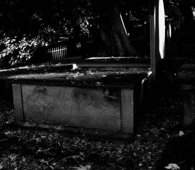A person asleep in bed in a darkened room